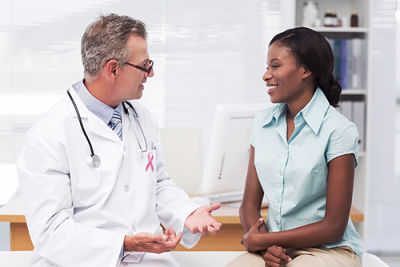 Male Physician is talking to a female Patient